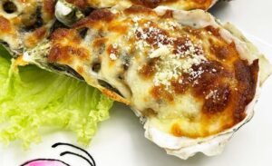 Live Oyster Baked with Cheese - close up shot (1)