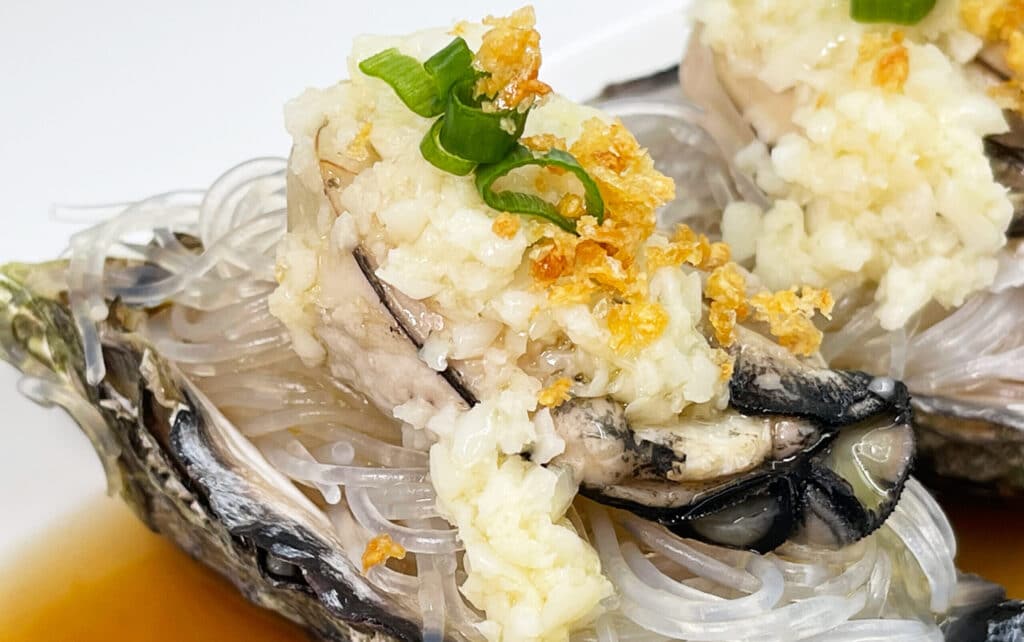 Live-Oyster-with-Minced-Garlic-Vermicelli-close-up-shot-scaled-e1639636795531.jpg
